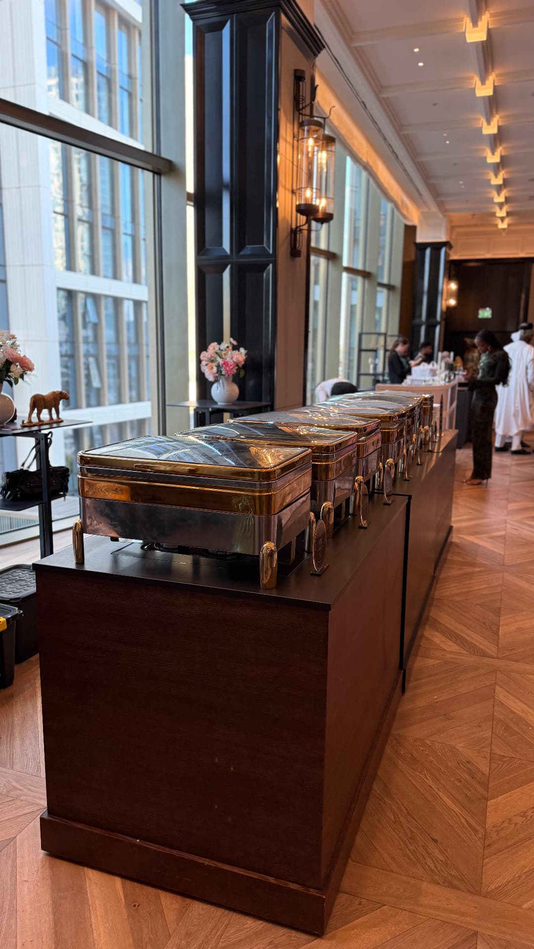 Adena's gold buffet service set up in a bright elegant event venue